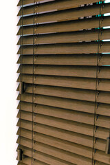Wood blinds close-up on white background. Bamboo blinds brown color.
