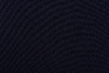 Background texture of dark blue woven fabric for wear made of soft cotton.