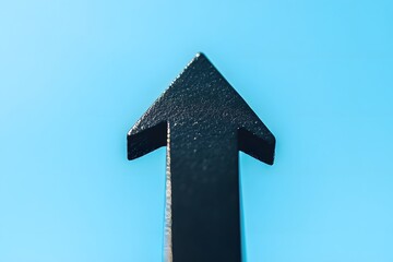 Naklejka premium Bold Black Upward Arrow on Light Sky Blue Background, Representing Business Growth and Progress.