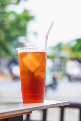 Fresh iced tea on the table with blurred background