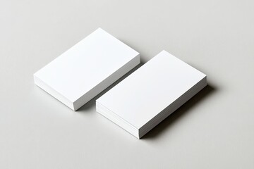 Two stacks of blank white business cards on a gray background. (1)