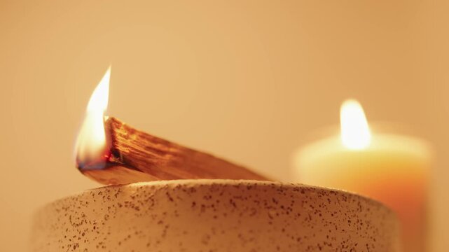 Close-Up of Burning Incense with Candlelight Ambiance