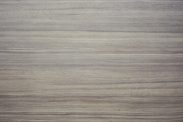 wooden surface with a horizontal grain pattern. The wood appears to have a light, natural finish with subtle variations in color and texture, giving it a realistic and organic look.