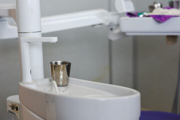 dental instrument tray setup. The tray contains several items typically used in a dental office