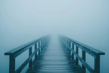 Obraz premium A solitary bridge shrouded in thick fog, its distant end disappearing into the misty unknown