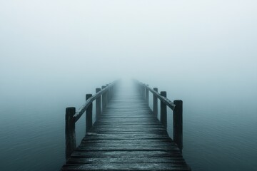 Obraz premium A solitary bridge shrouded in thick fog, its distant end disappearing into the misty unknown