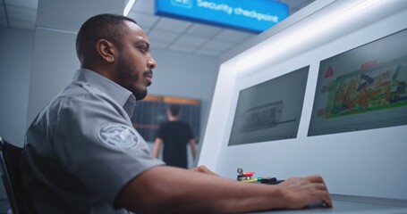 Airport Security Checkpoint: African American Security Officer Monitors Baggage Screening on...