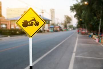 A bold yellow sign marking designated motorcycle parking spaces along the roadside, helping maintain organized and efficient parking for riders.