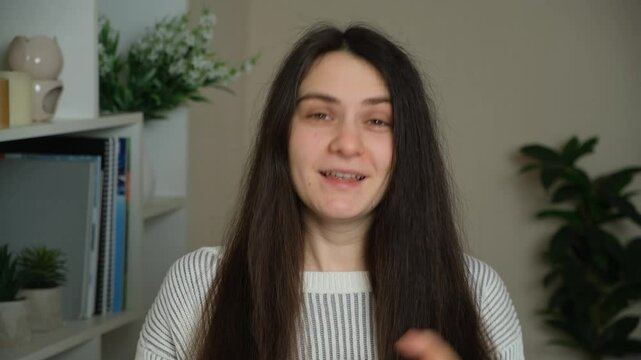A woman speaks emotionally while looking into the camera. Emotionality, indignation.