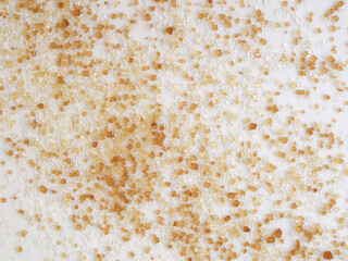 Sugar of more colors and different crystal size on a white background