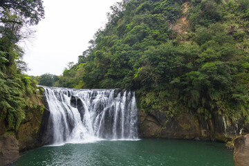 Fototapeta premium Shifen waterfall flowing through breathtaking Taiwan landscape