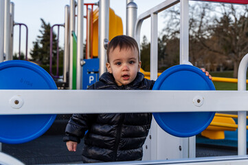 Young Toddler Playing at Playground in Bright Outdoor Environment