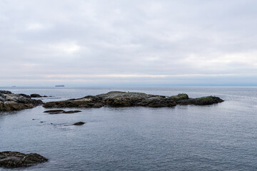 Scenic View of Rocky Coastline and Ocean in Overcast Weather