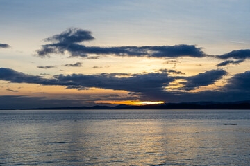 Scenic Sunset Over Vancouver Island Coastline With Serene Ocean Waters and Dramatic Clouds