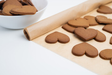 Crispy heart-shaped cookies on a light background. Delicious sweets and snacks