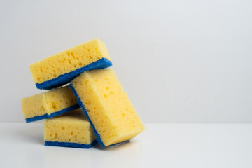 Colored sponges for washing dishes. Kitchen sponge on a light background.