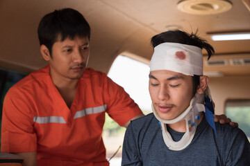 Paramedics help asian male injured had a broken head and bandage during sitting in ambulance car....