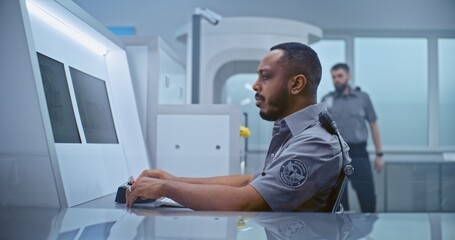 Airport Security Checkpoint: African American Security Officer Monitors Baggage Screening Moving on...