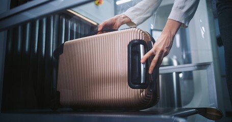 Airport Security Checkpoint: Passenger Puts Suitcase on X-ray Conveyor Belt for Luggage Scanning,...