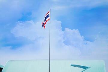 The Thai flagpole has a sky background.