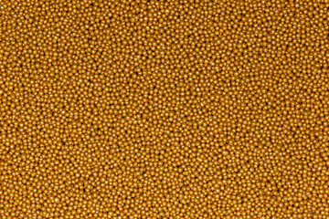 Vibrant Yellow Sugar Sprinkles Background: Macro Photography of Decorative Candy Pearls Used for Cake Decoration and Confectionery Garnish