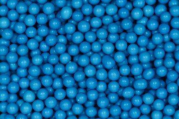 Vibrant Blue Sugar Sprinkles Background: Macro Photography of Decorative Candy Pearls Used for Cake Decoration and Confectionery Garnish