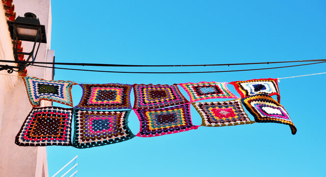 colorful crochet pot holders in the historic center of ferragudo algarve portugal