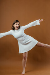 Naklejka premium A stylish and elegant young woman poses gracefully in a studio setting