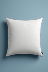 a close up of a white pillow with a red pip on it