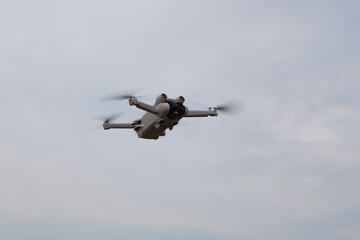 drone flying in cloudy blue sky, copy space.
