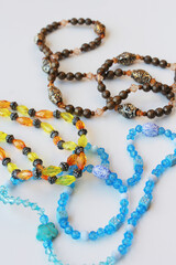 Beaded necklaces with brown, blue, and yellow beads. Stylish trendy fashion accessories, costume jewelry, handmade bijouterie on vertical white background. Perfect for jewelry design.