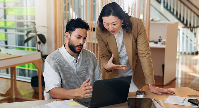Collaboration, laptop and problem solving with business people at desk in office for systems training. Assistance, help and question with supervisor talking to employee in workplace for management
