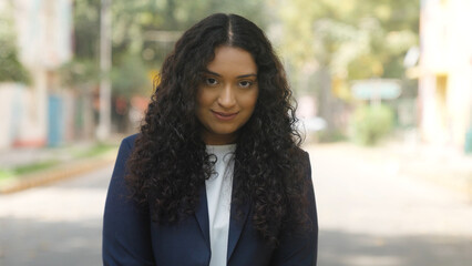 Fototapeta premium Shy Indian Businesswoman Looking in the Camera