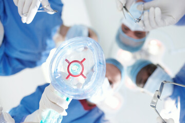 Doctors, mask and gas in surgery in theatre of anaesthesia safety, emergency procedure and ppe....