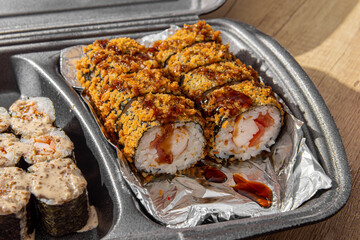 Fried sushi tempura in box. Sushi delivery at home