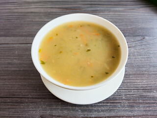White bowl with Krupnik Polish soup.