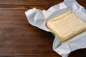 Butter that adds flavor to meals and is for breakfast on a wooden background