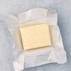 Cooking or breakfast package butter on vintage white background