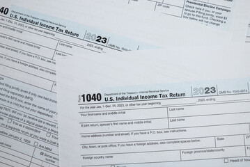 Obraz premium us tax forms 1040. For 2023, business tax time concept.