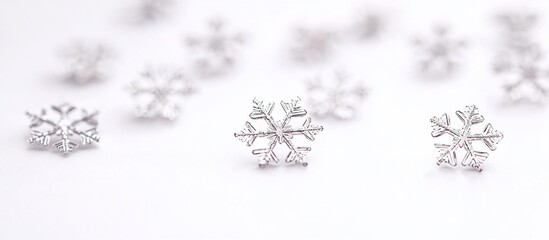 Silver snowflakes scattered on white, bokeh background, holiday decor