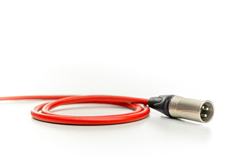 Red xlr cable lying on white background