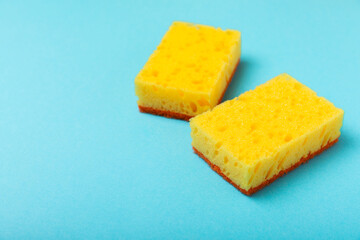 Colorful dish sponges on textured background. Kitchen sponge. Cleaning concept, cleaning service. Dishwashing liquid with clean and dirty dishes plate. Place for text, copy space. Wash the dishes.