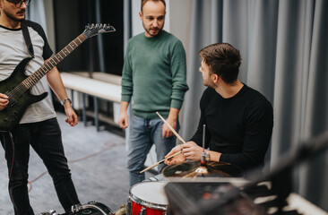 A group of musicians rehearsing in a professional studio, discussing music and practicing. Collaboration and creativity are evident as the band members work together to refine their performance.