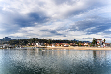 Ribadesella cityscape reflecting on the calm water of the sella river in asturias, spain