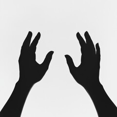 Obraz premium silhouette of two hands reaching out on a white background