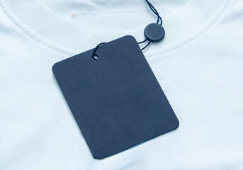 A blank fabric with an attached price tag, perfect for showcasing branding, pricing, or product...