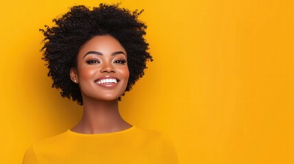 Smiling young Black woman with curly hair, wearing a yellow sweater against a vibrant yellow background. Studio portrait with bright, even lighting.