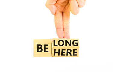 Belonging and belong symbol. Concept words Be here Belong on beautiful wooden block. Beautiful white background Businessman hand. Business motivational belonging and belong concept. Copy space.