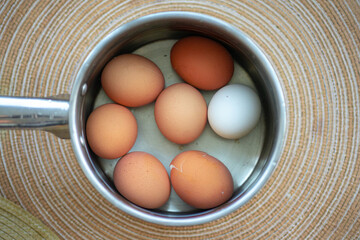 seven different eggs in a basket