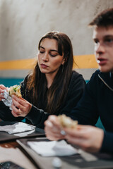 Two friends enjoying a casual meal together in a relaxed environment